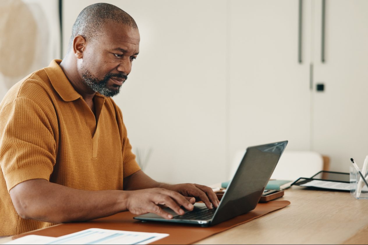 man referencing documents as he applies