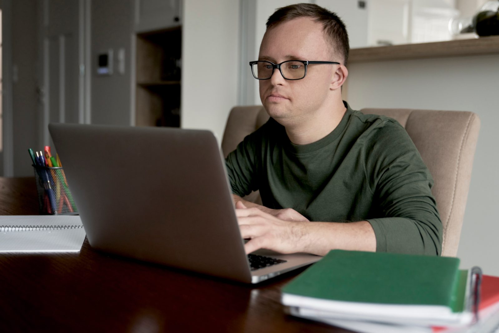 Adult learner requesting academic records on a laptop at home