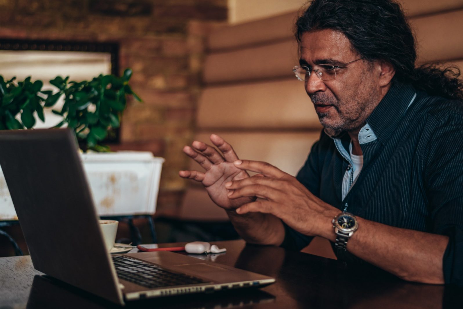 Adult studying safely at home at night, laptop glowing in a quiet room