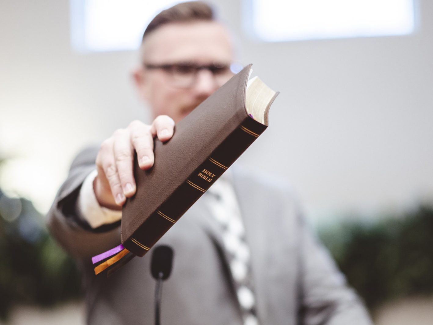 Man handing over a bible