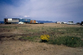 Construction company trailers arrive on site.