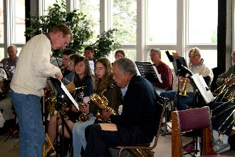 Multiple generations learning and playing together in the Alumni Room at Nazarene Bible College.